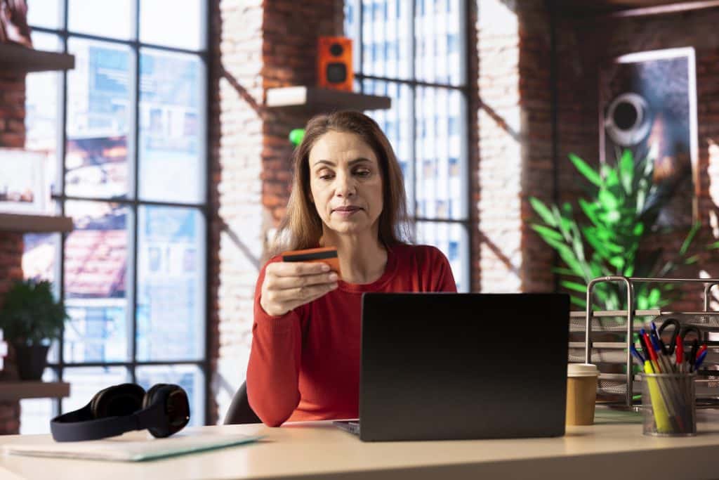 Consumer using a laptop to make an online purchase securely