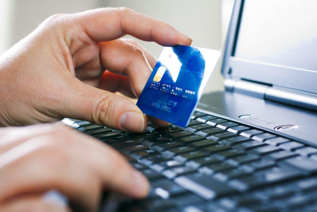 Consumer reviewing a credit card transaction while resolving an online purchase problem